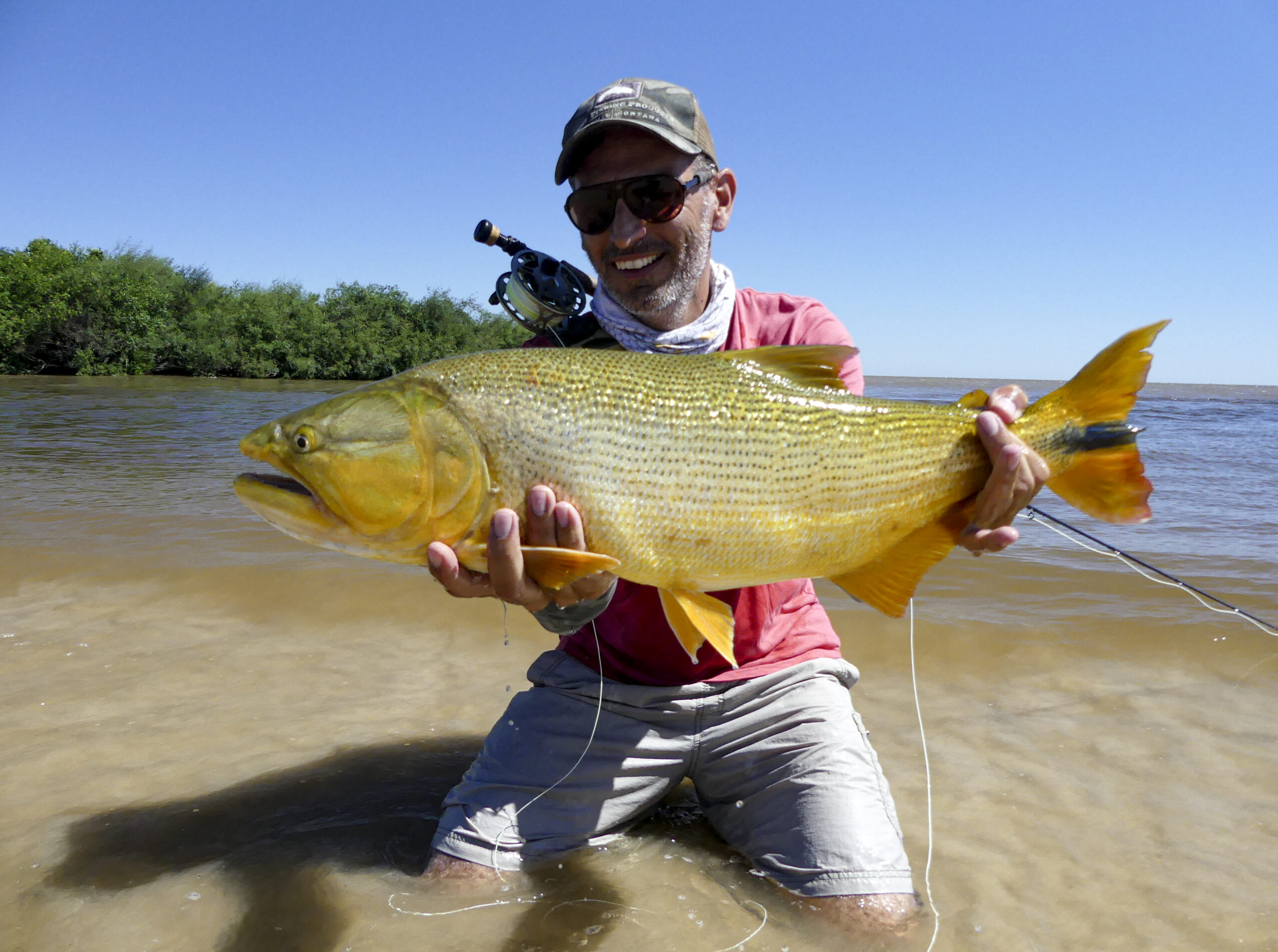 Mariano holding a 10 pounder Golden, caught from wading fishing